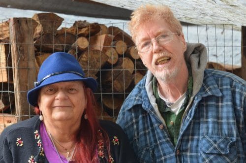 Standing before the very last of their firewood supply, Larry and Annita Henderson remain hopeful someone will keep the needed KP Firewood Bank running. Photo: Lisa Bryan, KP News