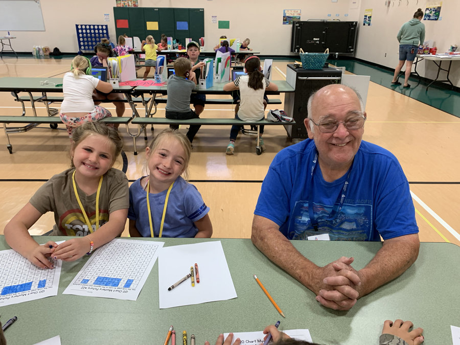 Second-graders Evelyn Hand and Graycie Bump with CISP mentor Mike Fay.