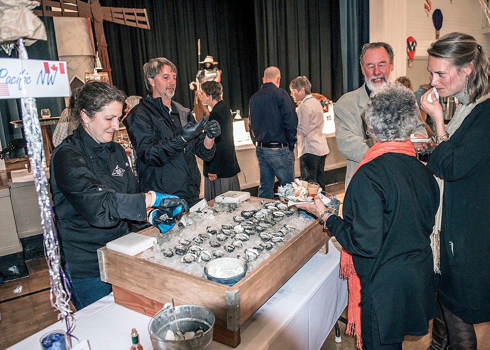 Photo: Ed Johnson, KP News Erin Ewald and Brian Phipps from Taylor Shellfish Co. serve local oysters at the Flavors of Fall event Oct. 8. NIKON D750, 24mm, f/2.8, ISO 3200