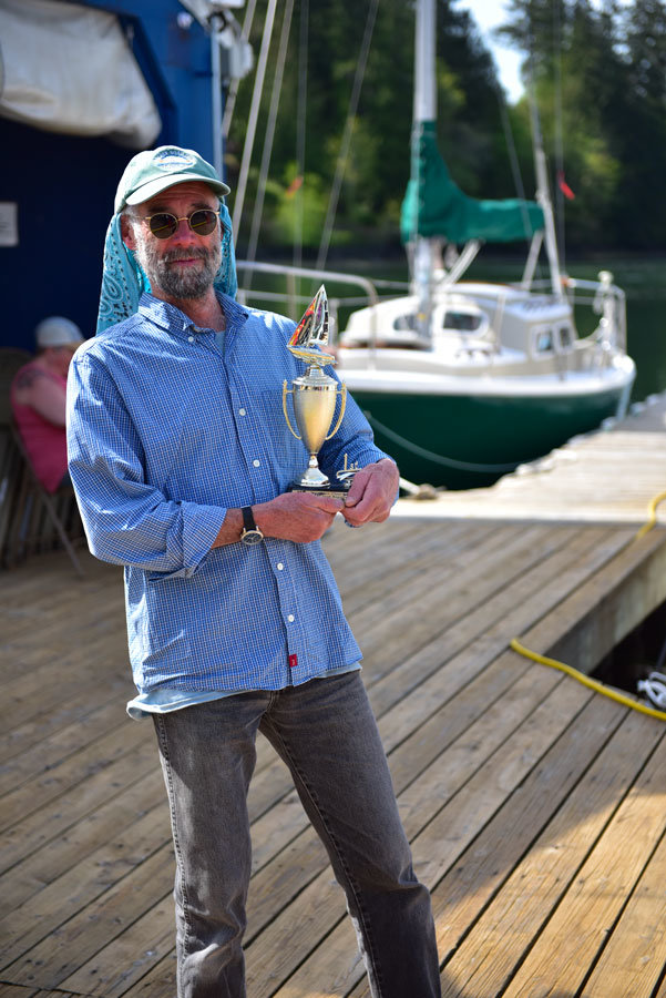Sailor Tom Tallman takes home the trophy after winning at the Longbranch regatta. Photo: David Zeigler, KP News