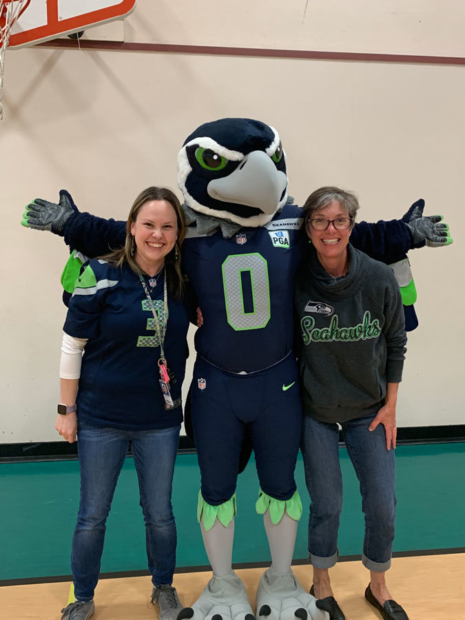 Seahawks mascot Blitz with Evergreen Elementary first grade teachers Jennifer Martin and Beth Porter during his visit to the school May 20 to celebrate the student body's summiting “Mount Ever-read” — reading 2,000 books since October. Photo: Tricia Endsley