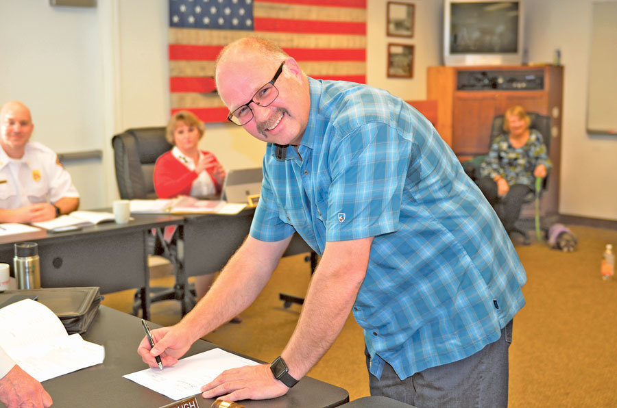 After an exhaustive search, the Board of Commissioners of Key Peninsula Fire District 16 selected Dustin Morrow as the new fire chief. Morrow signed a contract two weeks later at the March 12 commissioners meeting and started work in April. One of his first tasks was to promote a permanent EMS levy for the district, which KP voters approved in a supermajority vote Aug. 6. Photo: Lisa Bryan, KP News