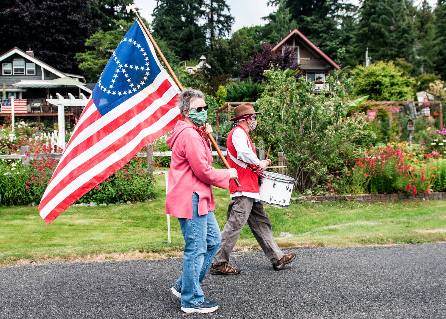 A scaled-back Fourth of July parade in Home, where roughly a third of the participants wore masks.