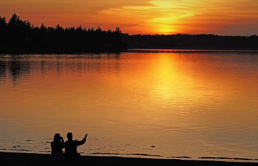 A couple enjoys sunset along Case Inlet.