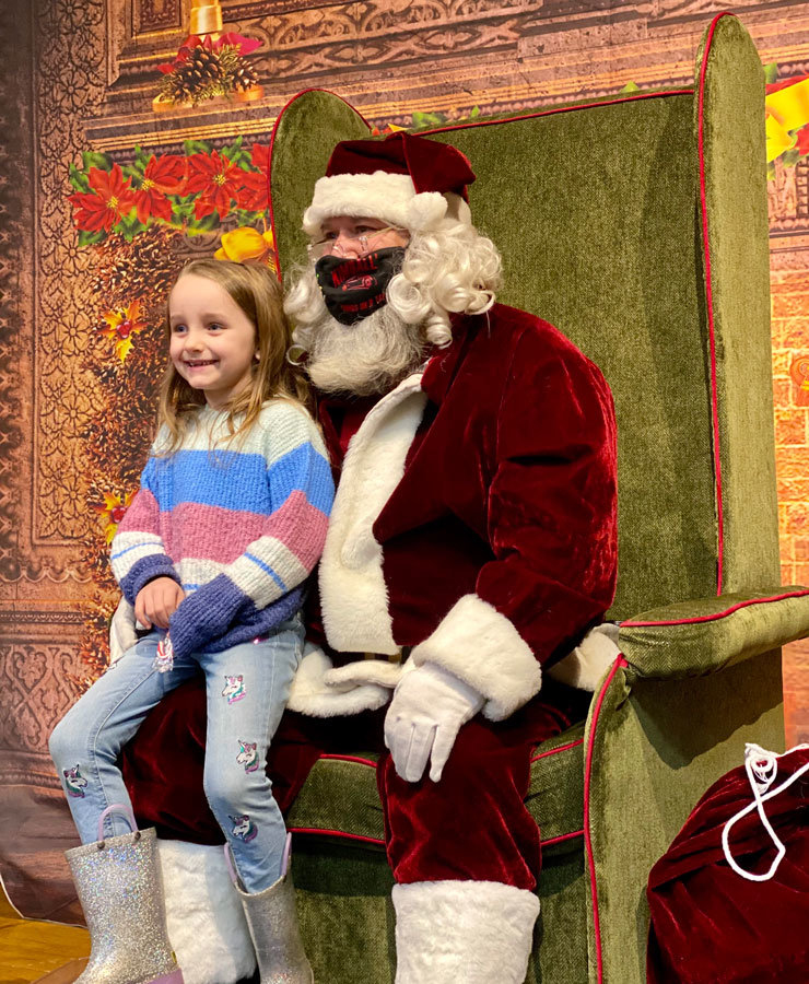 Piper Glennon, age 5, atop Santa’s lap at Winter Warm-Up.