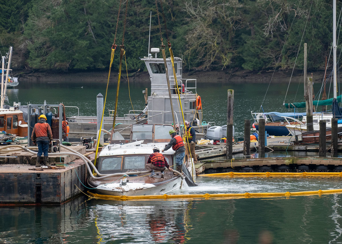 A sunken derelict vessel about to be hoisted from Lakebay Marina.