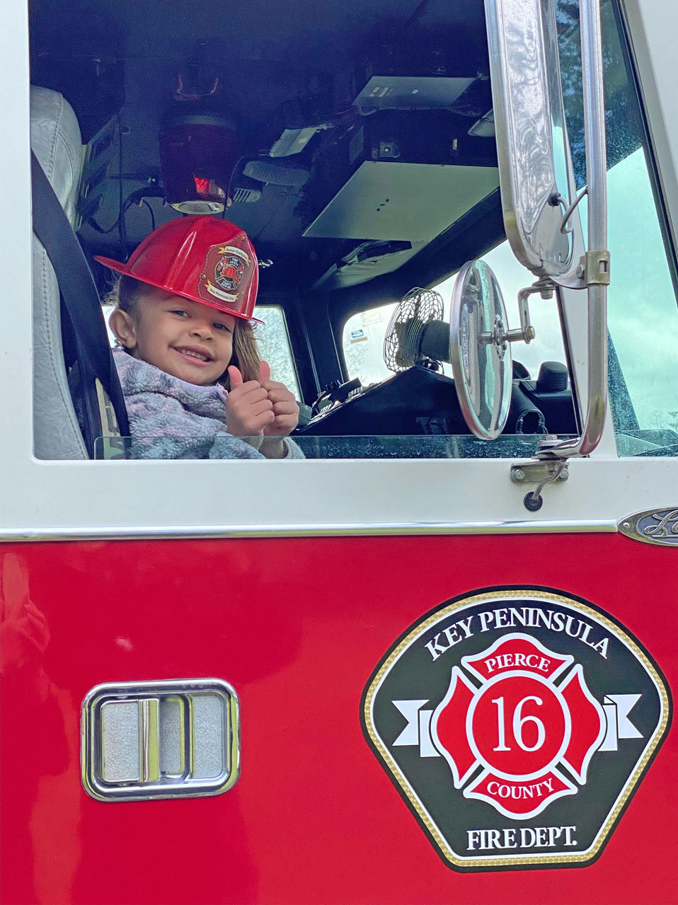 Faith Mathis of Key Peninsula Cooperative preschool was the top fundraiser for its trike-a-thon, earning a ride in a fire engine.