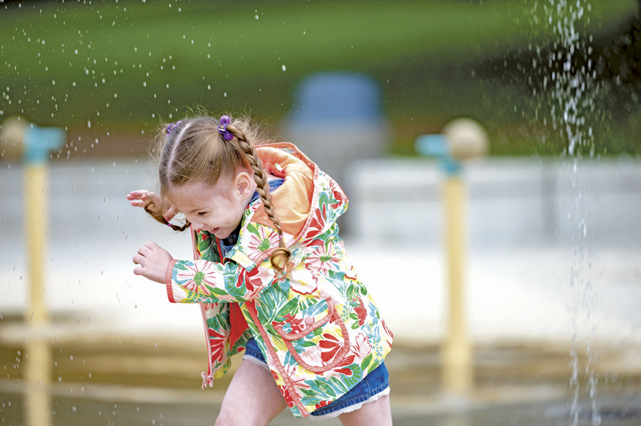A happy constituent celebrates the second, post-pandemic, grand opening of the splash pad at Gateway Park May 27.