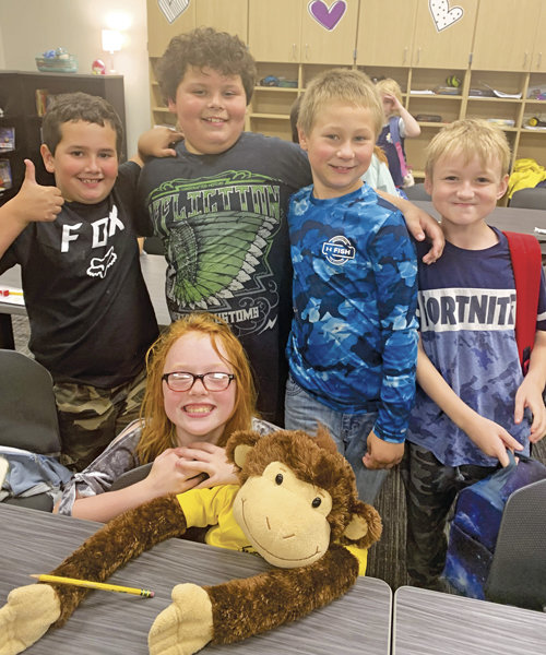 Classmates, from left to right, Evan Larson, Josiah Gochmansky, Ronan Collins and Derek Chambers. The student sitting with the monkey is Peyton Hill.