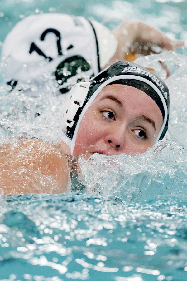 PHS senior Alli Frederickson focuses on water polo action.