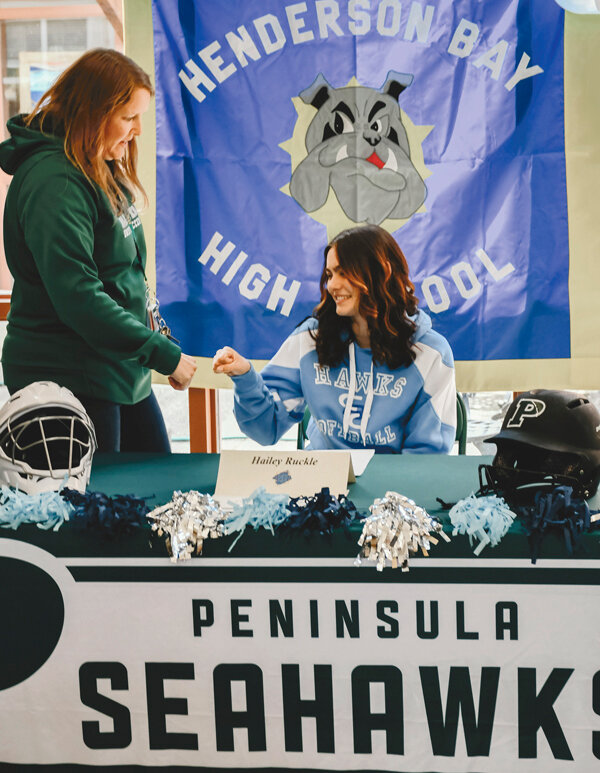 PSD Success Coach Jennifer Buys (left) congratulates Henderson Bay High School senior Hailey Ruckle on signing a letter of intent to play softball at Columbia Basin College next year.